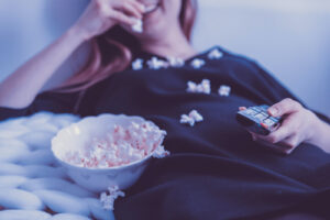 Girl watching movie and eating popcorn