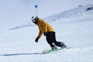 Man snowboarding down snowy mountainside
